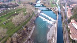 Aerial shot, beautiful little river in the middle of the fall nature in Italy, Tuscany, filmed with drone