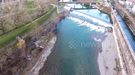 Aerial shot, beautiful little river in the middle of the fall nature in Italy, Tuscany, filmed with drone