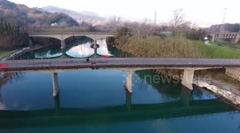 Aerial shot, beautiful little river in the middle of the fall nature in Italy, Tuscany, filmed with drone