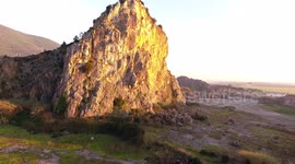 Aerial shot, Upezzinghi tower on the rocky outcrop in Italy, Tuscany, on the sunset light, filmed with drone