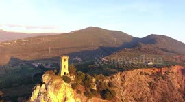 Aerial shot, Upezzinghi tower on the rocky outcrop in Italy, Tuscany, on the sunset light, filmed with drone