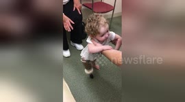 Twenty month old girl takes first steps with prosthetic leg