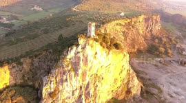 Aerial shot, Upezzinghi tower on the rocky outcrop in Italy, Tuscany, on the sunset light, filmed with drone