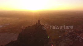 Aerial shot, Upezzinghi tower on the rocky outcrop in Italy, Tuscany, on the sunset light, filmed with drone