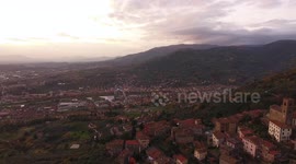 Aerial shot, gorgeous classic small italian village on the hill flyover, in middle of the green nature, made with drone