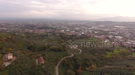 Aerial shot, gorgeous small village on the hill flyover, in middle of the fall colors, filmed with drone