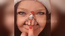 Painted Santa twerks on woman's nose