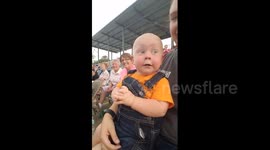 15-month-old child gets incredibly excited about live motor racing