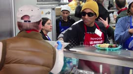 Musician Pharrell Williams serves up Christmas dinner to homeless