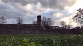 Time lapse video of grass moving because of the wind with big ancient walls on the background, selective focus