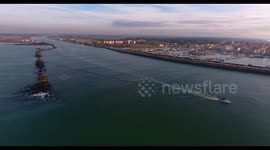 Some fishermen houses with huge nets outside situated in the middle of the sea, in Tuscany, Italy, filmed with drone