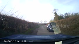 Motorist drives down country lane with bonnet up