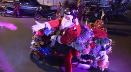 New Year Santa arrives by motorbike