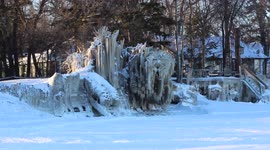 Frozen trees and docks on lake shore in Canada