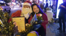 Man dressed as Santa Claus gives New Year wishes in Thailand