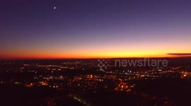 Planet Venus and moon appear over New Jersey during twilight