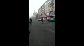 Woman drove vehicle to shove police car after caught vandalizing shop windows on street in northern china