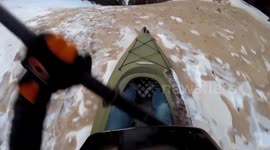 Daredevil kayaks down snowy hill straight onto frozen lake