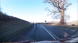 6 Cyclists riding uphill in a safe way on main road