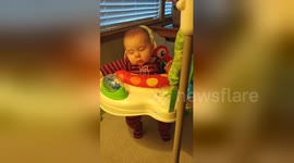 Baby fights sleep to keep jumping longer