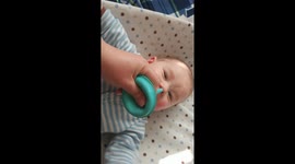 Cute baby thinks suction bulb is funny