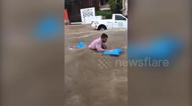 Brit tourists dubbed crazy foreigners float down road in flood