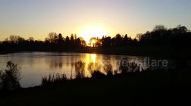Stunning sunset over frozen lake in Lydiard Park, Swindon