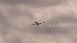 Light aircraft pilots picking up advertising banners are remarkably skillful