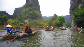 Tam Coc, Vietnam - Girls row boats with their feet