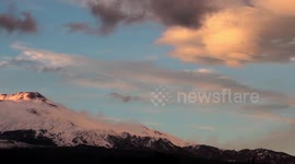 Snow and lenticular clouds over Mount Etna