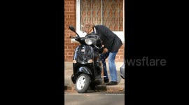 Nigel Havers well known actor riding a scooter in chelsea