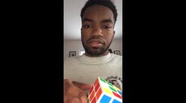 Young man solves Rubik's Cube with one hand
