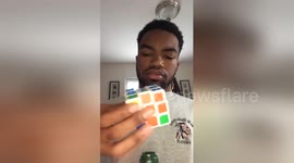 Young man solves Rubik's Cube with one hand