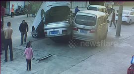 SUV reverses into car and flips it