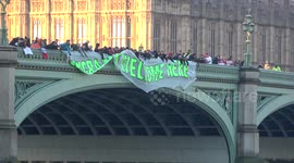 Anti-Trump protesters unfurl banners on Westminster Bridge, London