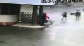 Firefighter carries falling down elderly man in rainstorm