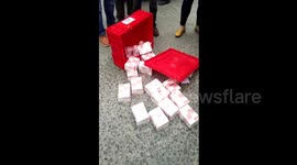 Cash carrier drops money by mistake, people step in to protect it