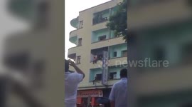 Firefighters ABSEIL down building and KICK suicidal man to safety