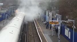Smoke billows from train at London station