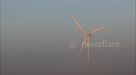 Wind turbine emerges from frozen mist