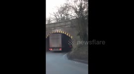 Foreign lorry having a close shave under LOW bridge