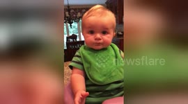 Baby tries apple for the first time, reacts with disgust