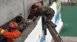 Firefighters rescue an elderly man trapped in the gap between two walls