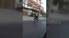 Hilarious moment two cats ride on a motorbike wearing little helmets