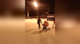 Newsflare Edit - Father skating with baby carriage