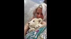 Cuddling with a white lion
