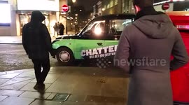 Taxi driver plays his electric Guitar whilst parked in Piccadilly Circus