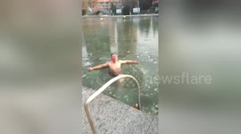 Swimming teacher swims under ice in risky move