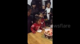 Table overturns when kids try to blow out the candles on birthday cake