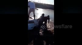 Passersby rescue woman who drove car into freezing river